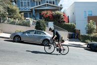 A Man Riding a Bicycle in an Uphill Road