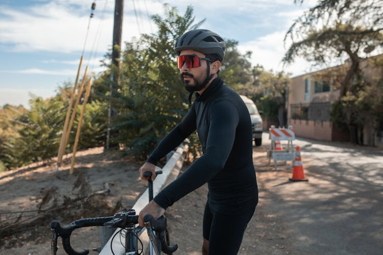 A Cyclist In Black Long Sleeve Jersey And Cycling Shorts