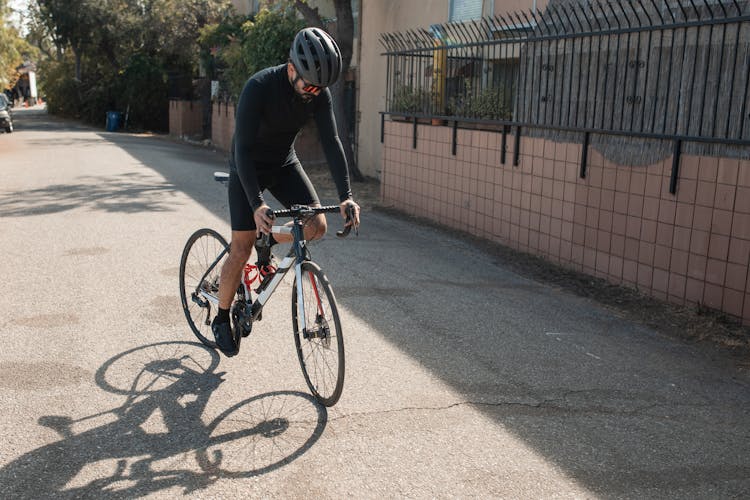 A Man Biking In The Suburban Street
Cle