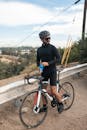 A Man Riding His Bicycle Stopping for a Drink
