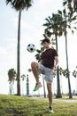 A Man Juggling a Soccer Ball with His Knee
