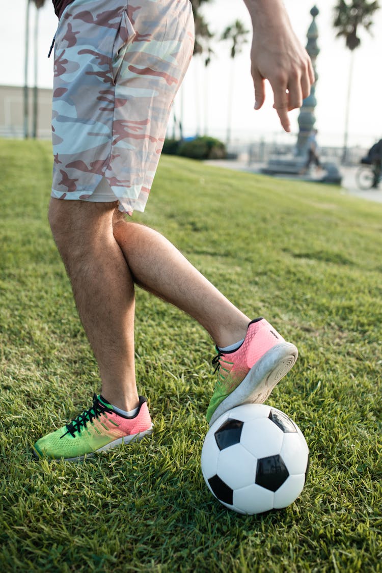 A Person Kicking A Soccer Ball