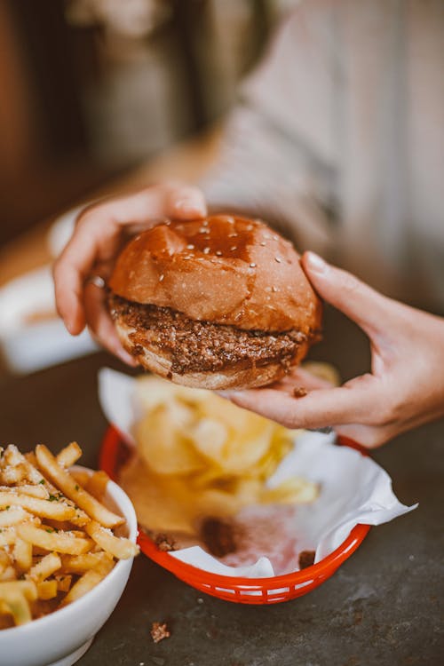 Free A Person Holding a Hamburger  Stock Photo