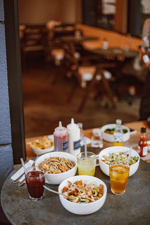 Free Bowls of Food and Drinks on the Restaurant Table Stock Photo