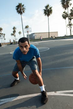 Dynamic shot of a man with a basketball on an outdoor court, perfect for sports themes.