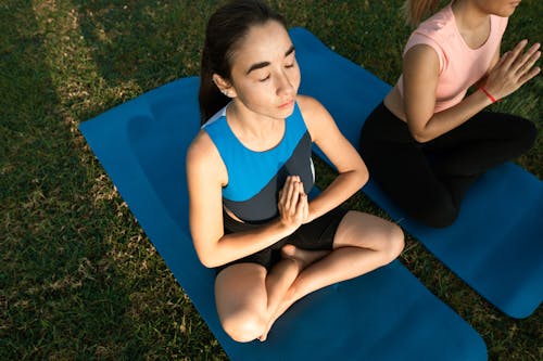 Free Women Meditating Outdoors Stock Photo