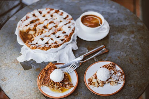 Slices of Brown Crepes with Scoops of Vanilla Ice Cream on Top