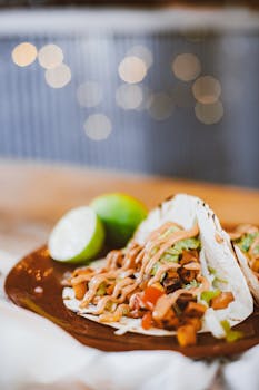 Mouth-watering tacos topped with fresh vegetables and sauce, perfect for food lovers.