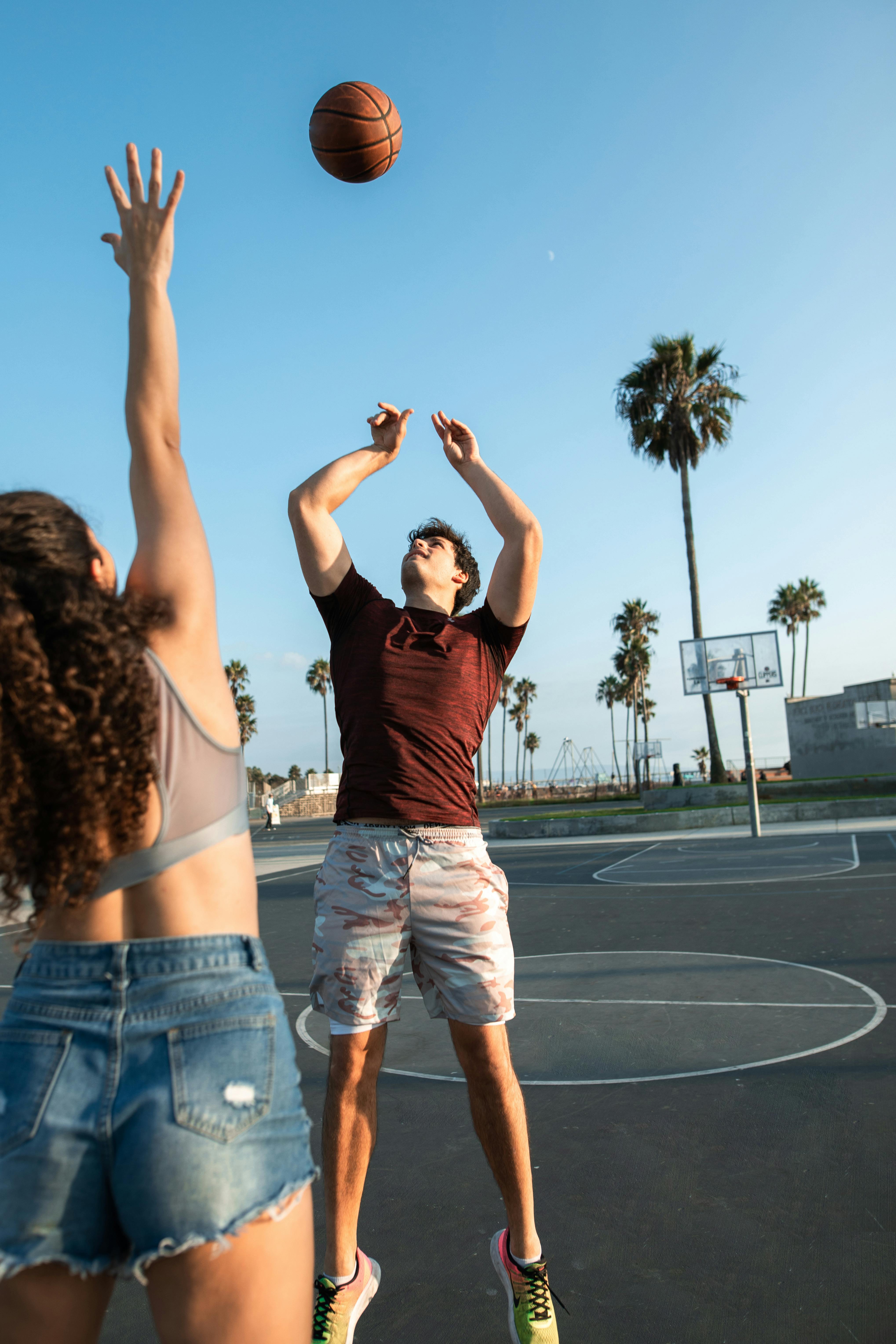 a man and a woman playing basketball