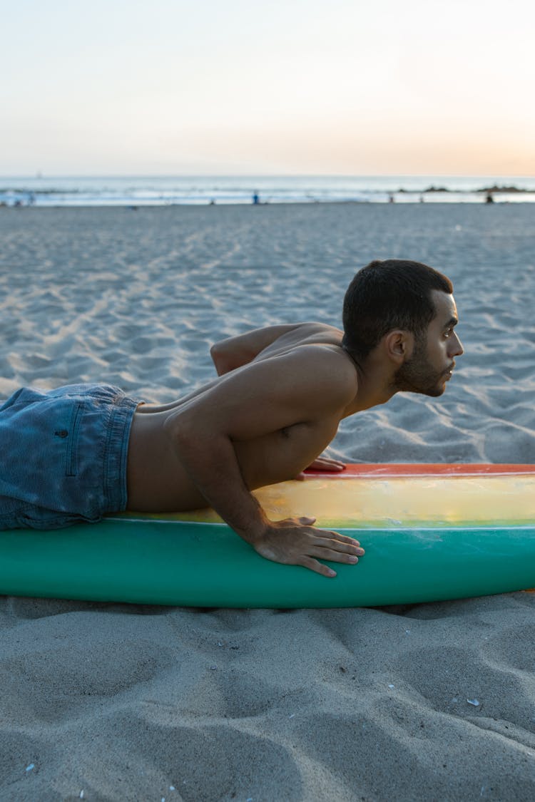 A Shirtless Man Learning To Surf