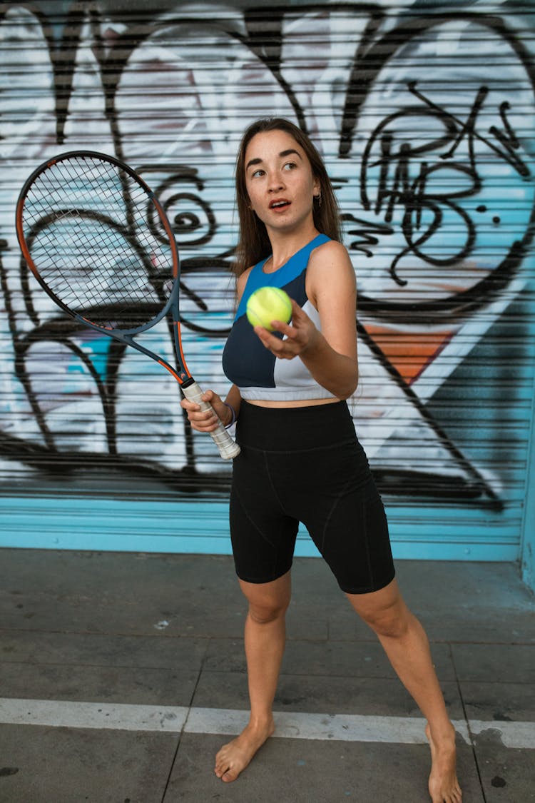 Woman In Tank Top Holding A Tennis Ball