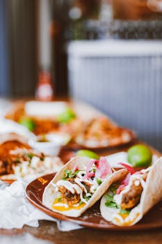 Close-up of tasty tacos with fresh toppings on a rustic wooden table, perfect for a food blog or menu.