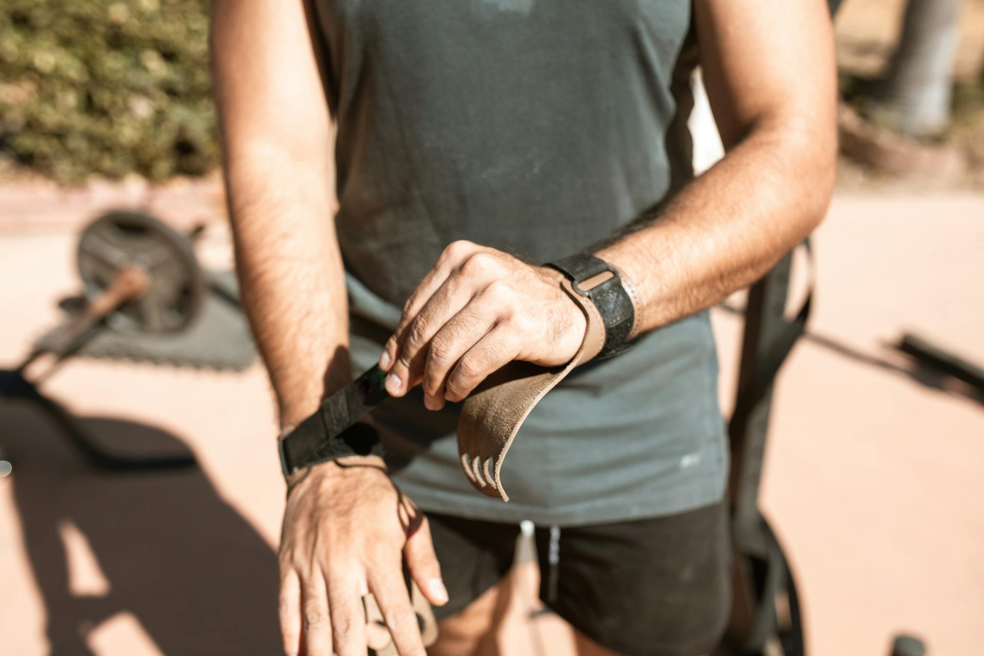 Man Putting on Wrist Straps