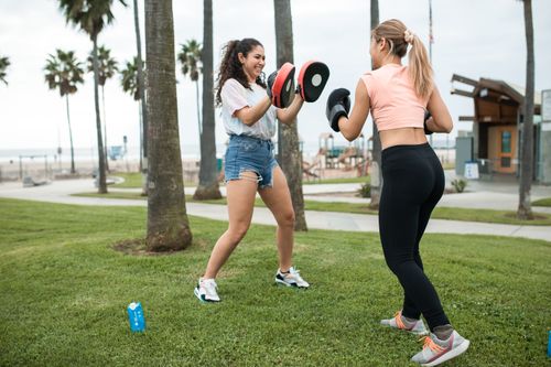 Free Two women engaging in a dynamic boxing workout session outdoors, enjoying fitness training. Stock Photo