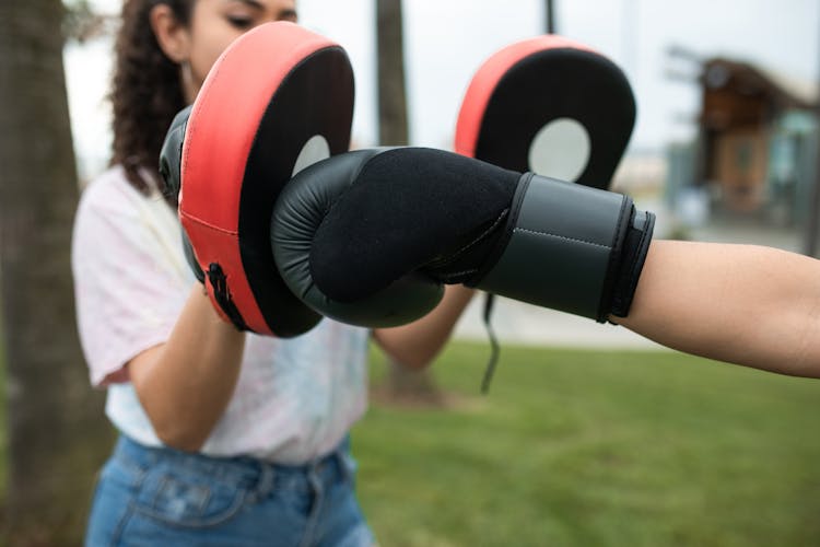 Woman With Wearing A Boxing Mitts While On Training