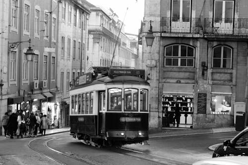 Grayscale Photo of Tram on Road