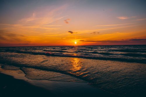 Free Stunning sunset over the serene Polish coast with vibrant colors reflecting on the ocean waves. Stock Photo