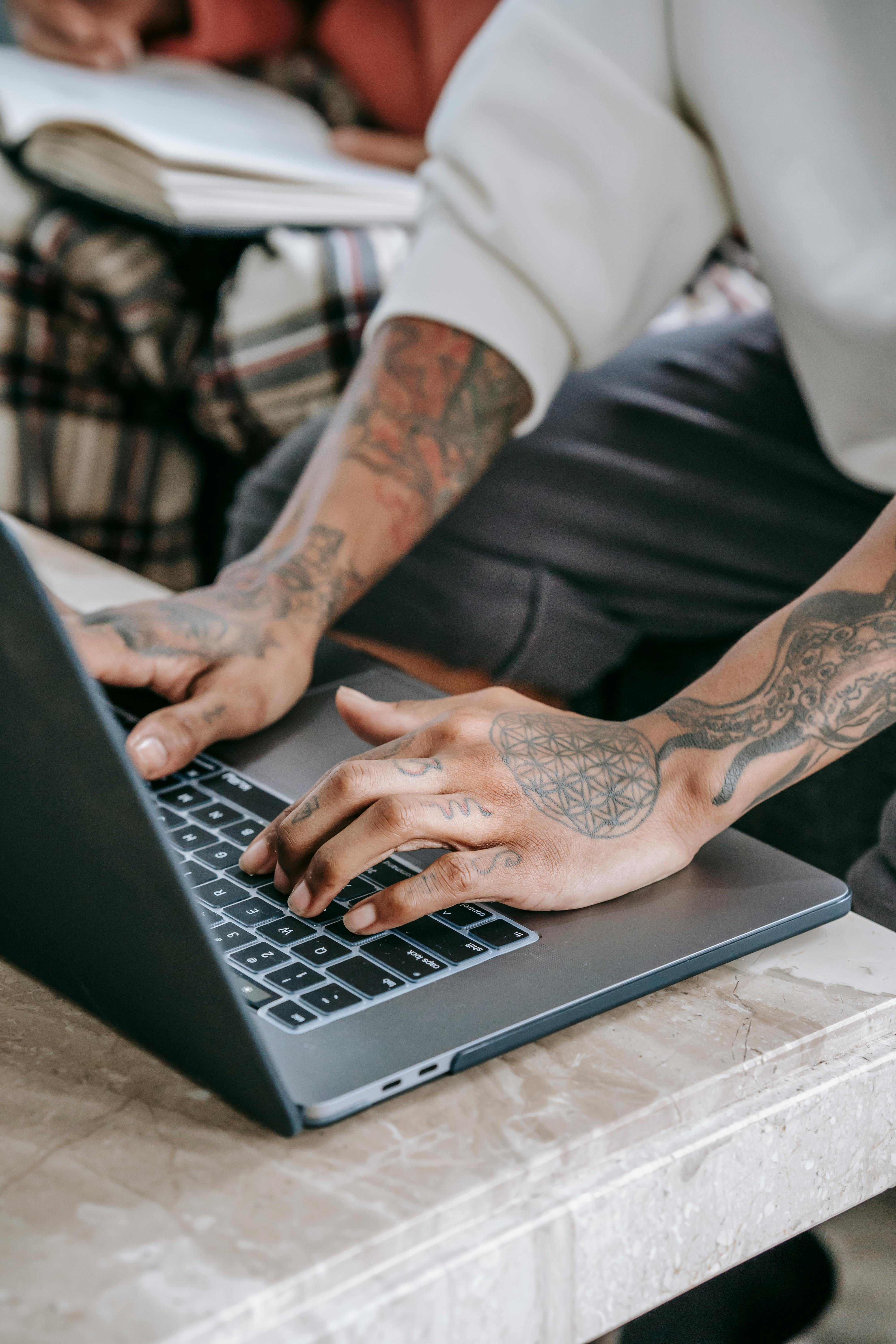 crop person typing on laptop at home