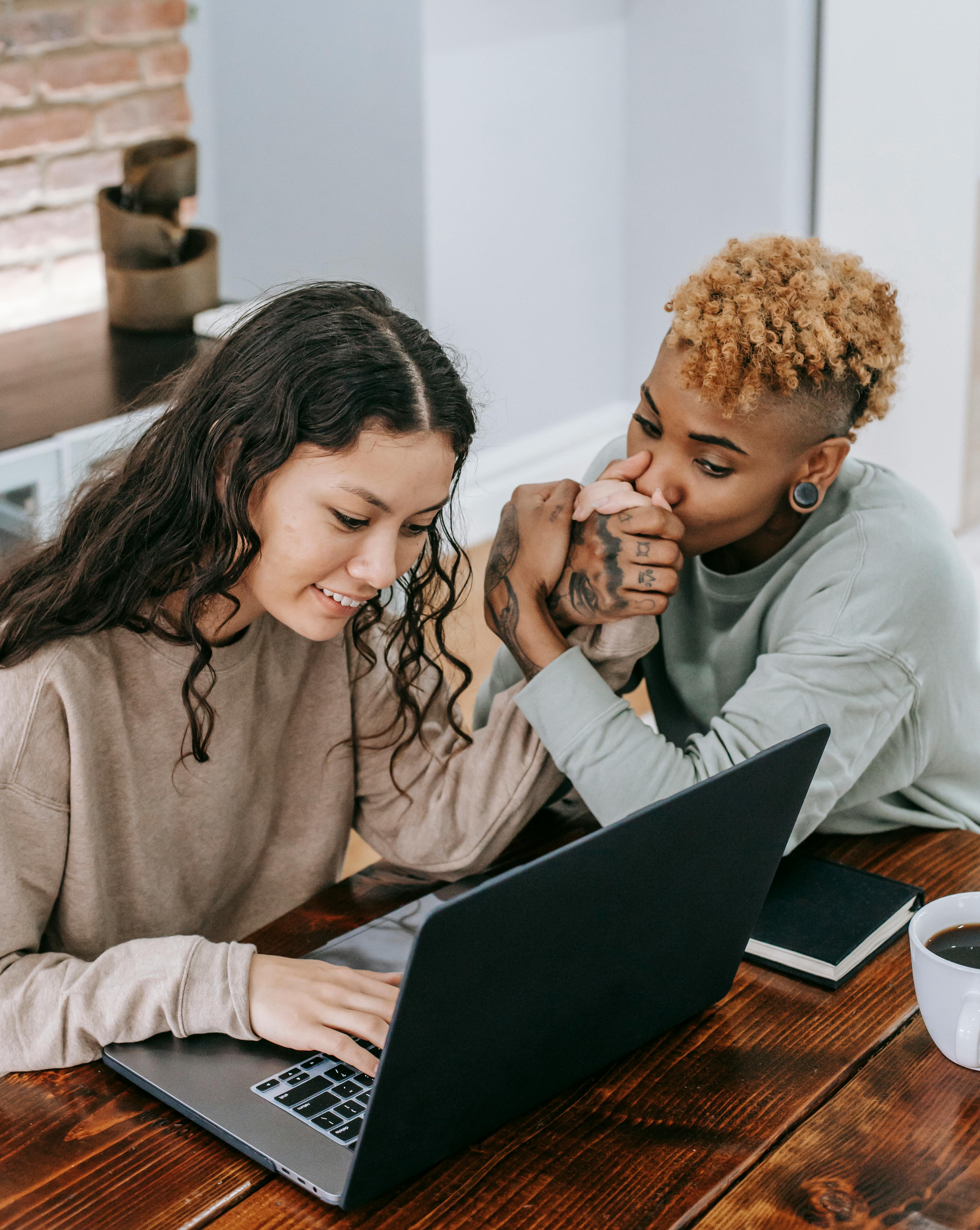 happy diverse couple using laptop