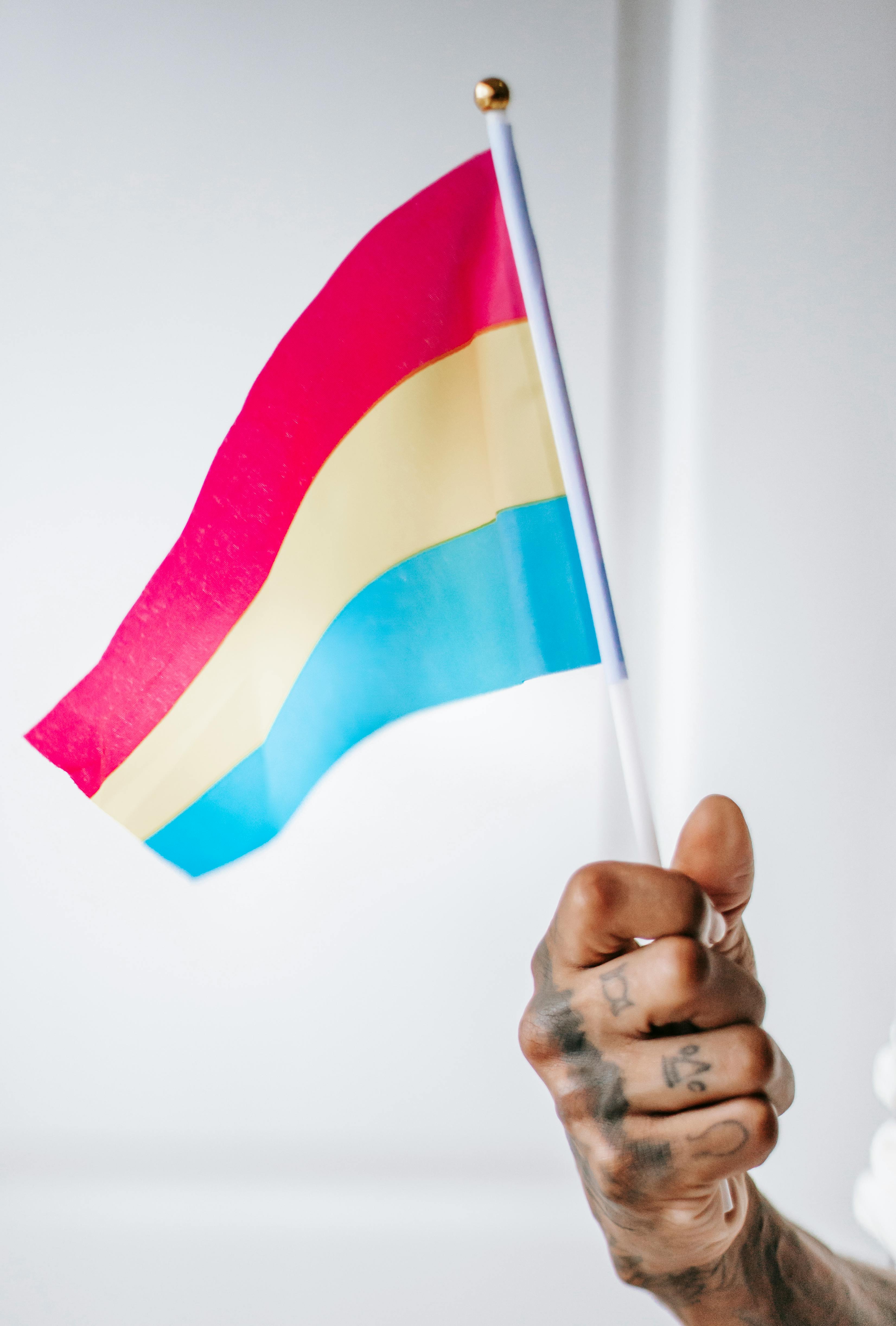 tattooed hand with pansexual flag