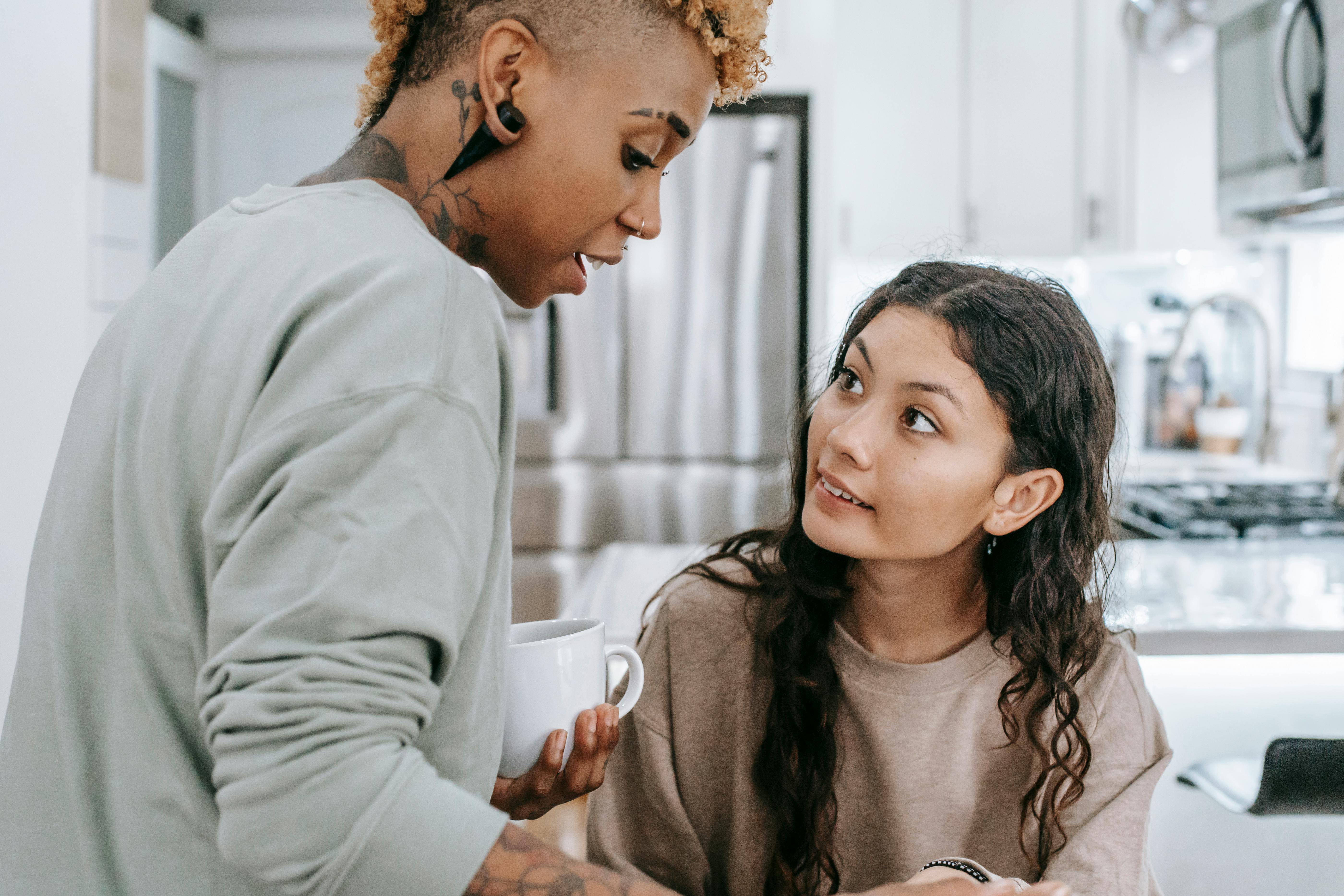 multiethnic women talking in kitchen