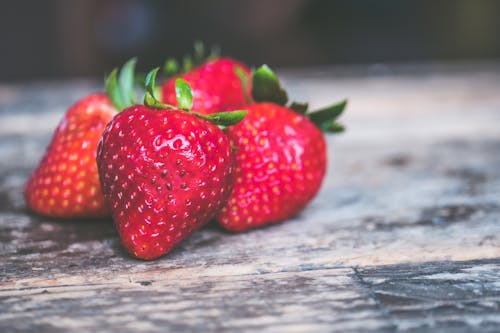 Free Shallow Focus Photo of Strawberries on Gray Wooden Surface Stock Photo