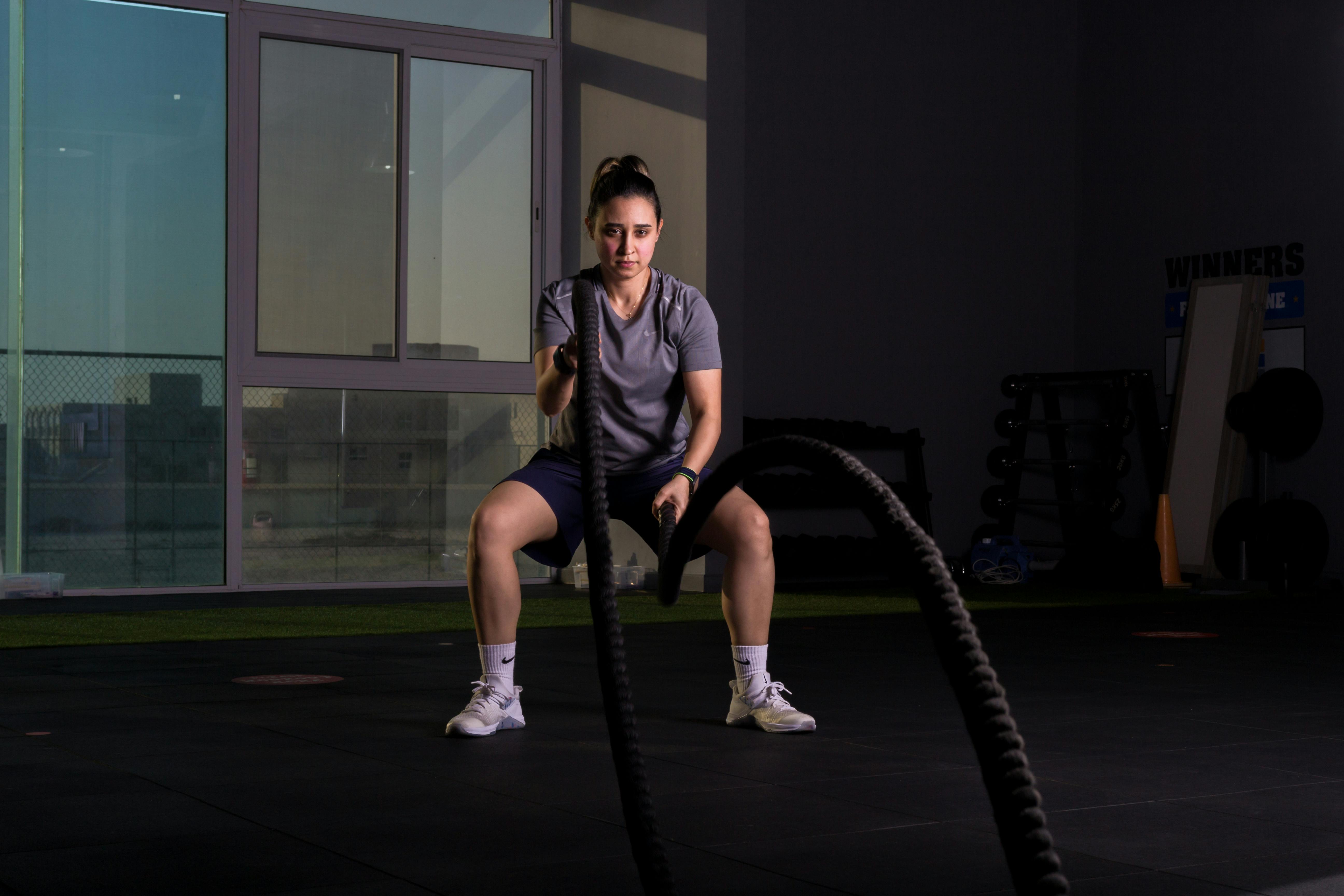 A Woman Using Battle Ropes · Free Stock Photo