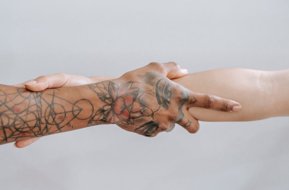 Free Crop hands holding each other Stock Photo