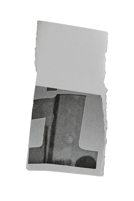 A grayscale torn piece of paper featuring a textured design on a white background.
