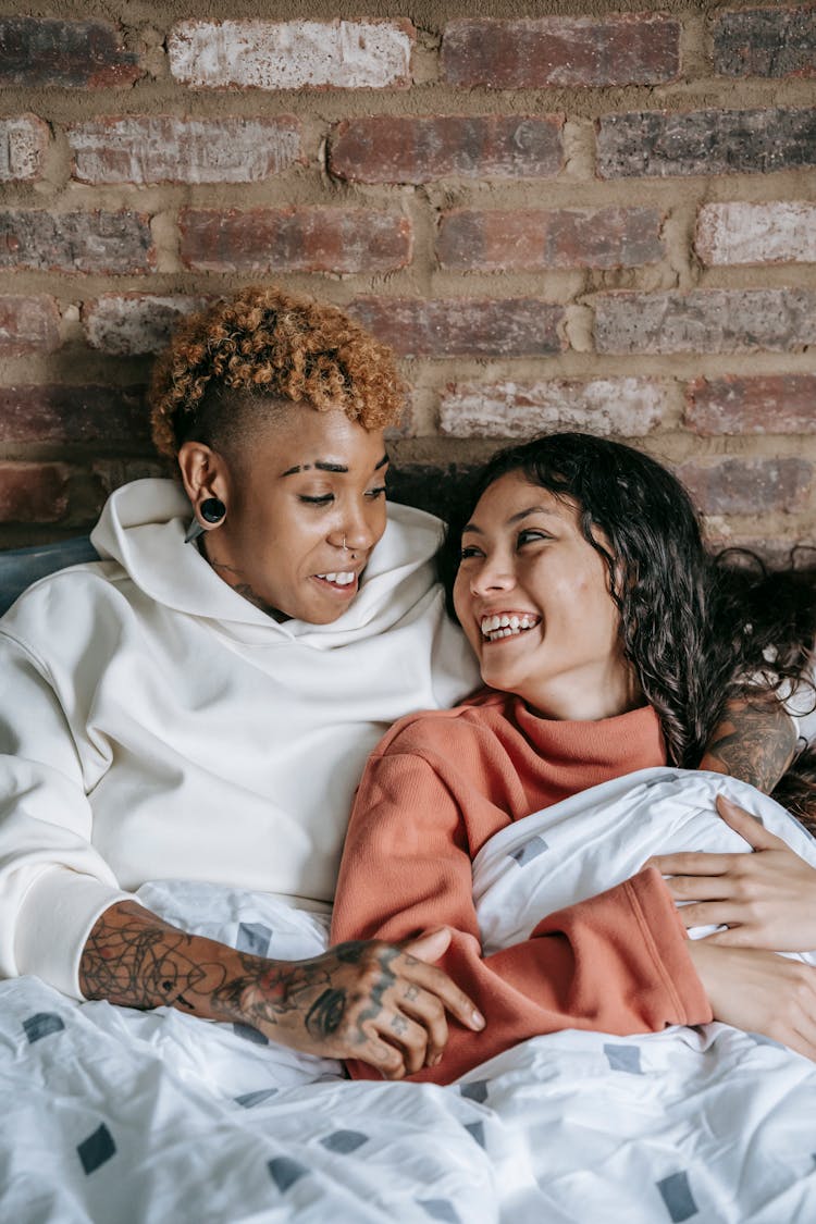 Laughing Lesbian Couple In Bed