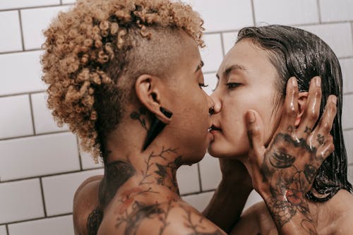 Free Passionate diverse couple taking shower together Stock Photo