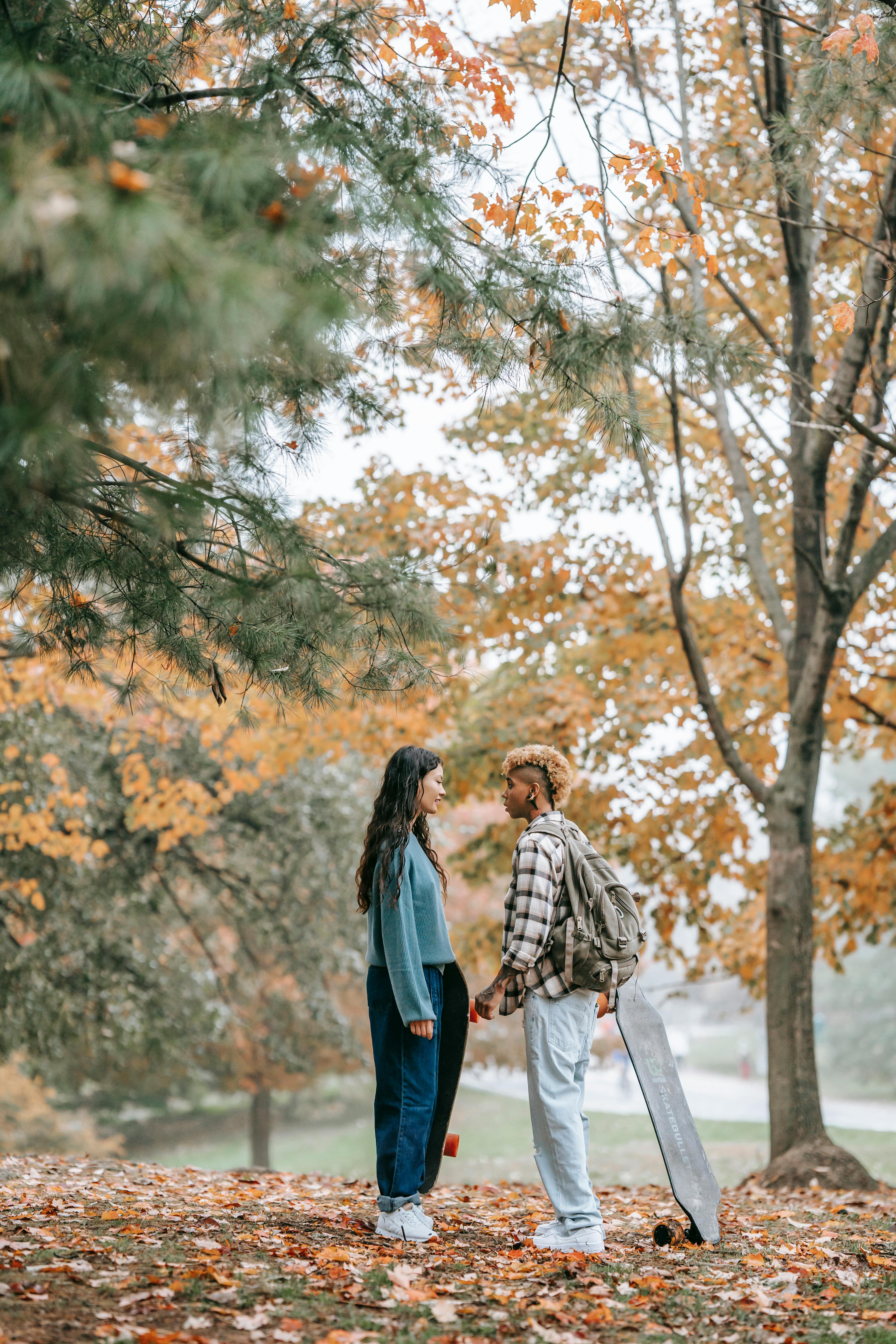 young women in park looking at each other