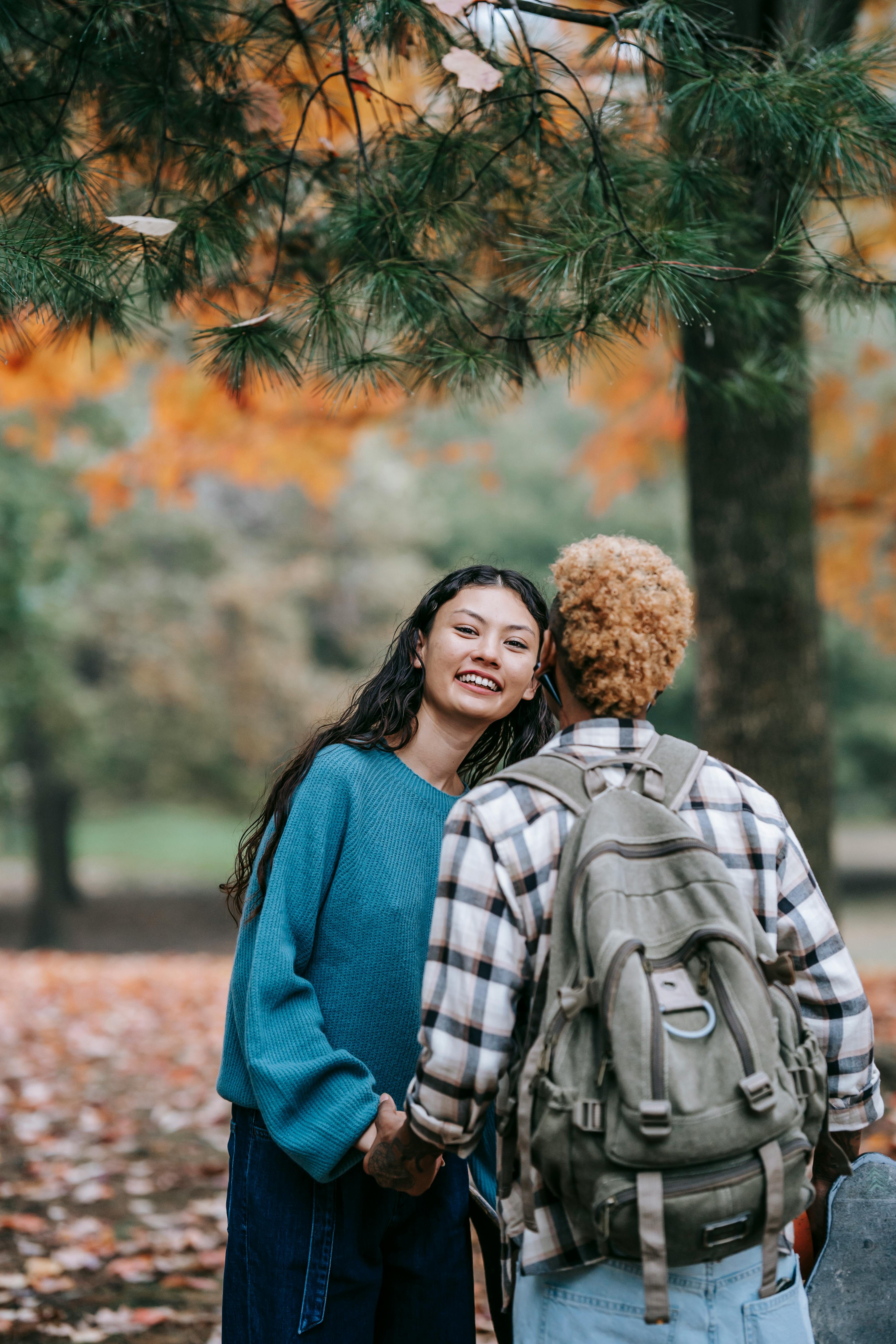 cheerful multiethnic couple in park