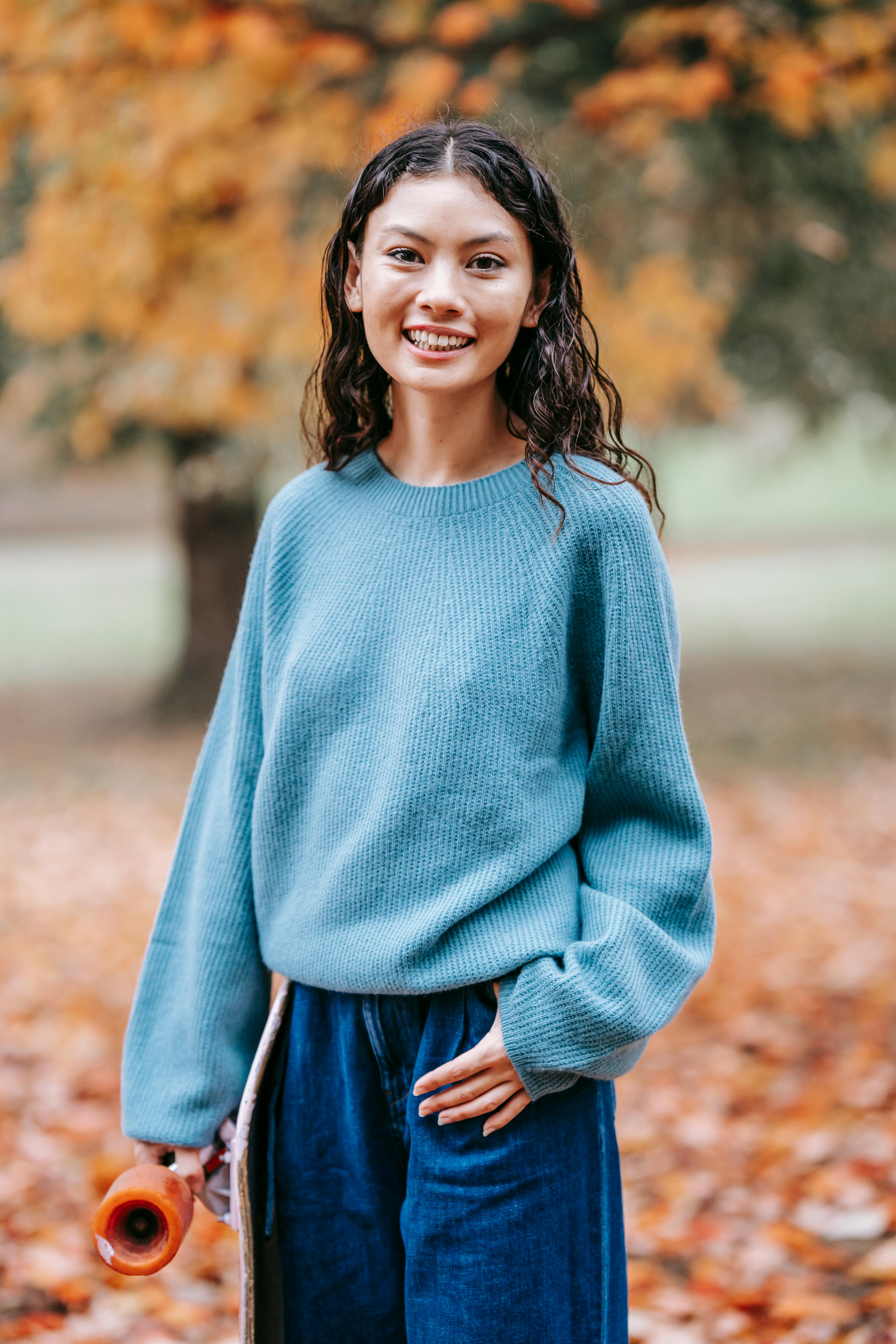 smiling ethnic woman in autumn park