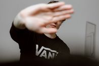 Unrecognizable man with reached arm near wall