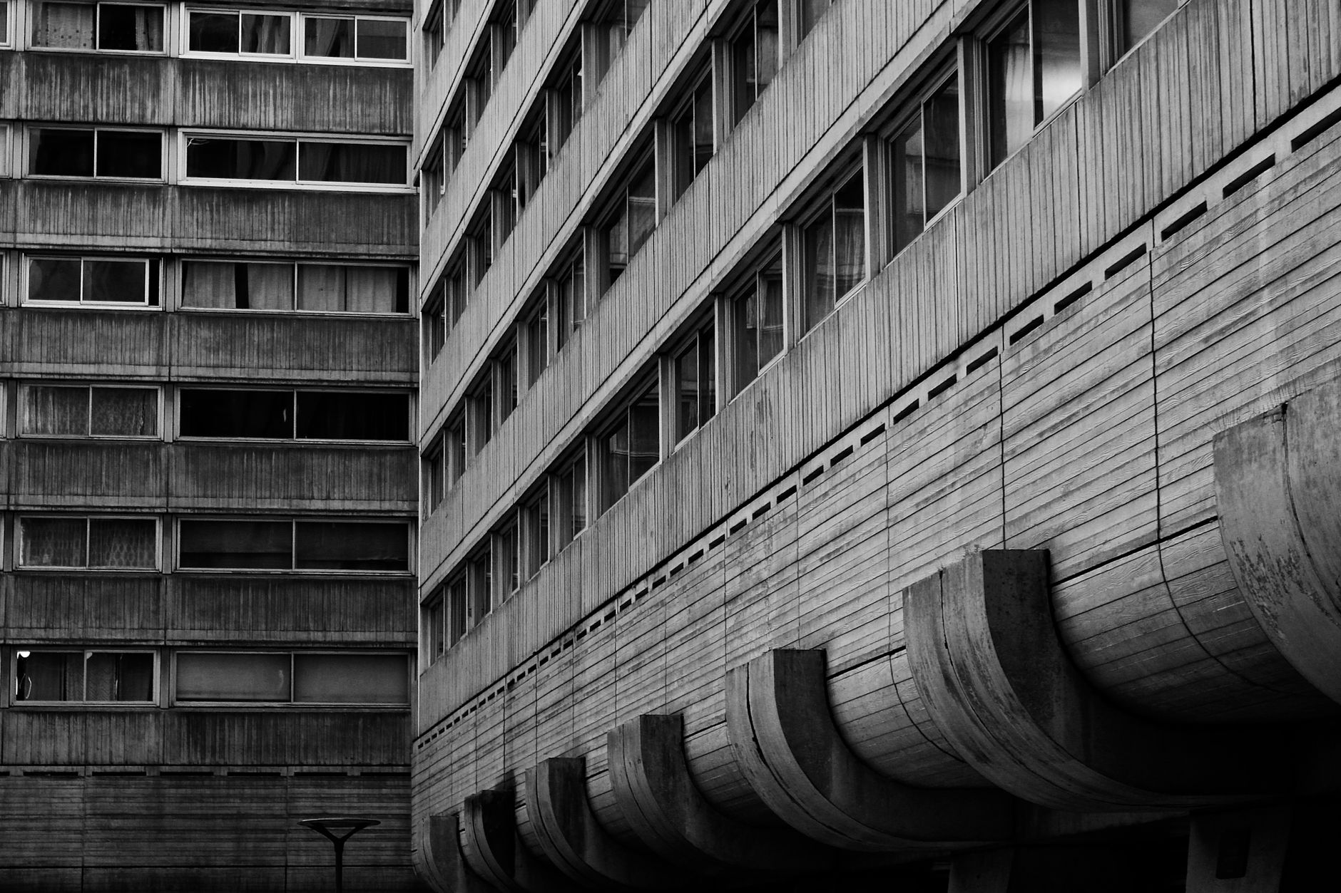 Grayscale image showcasing the raw concrete texture of Brutalist architecture.. grayscale, image, showcasing