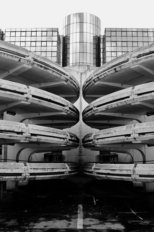 Free Symmetrical view of modern architecture with concrete and glass elements in grayscale. Stock Photo