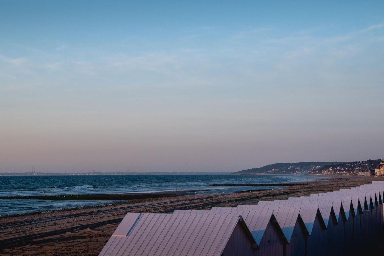 peaceful beach scene with colorful huts at villers sur mer normandy pe