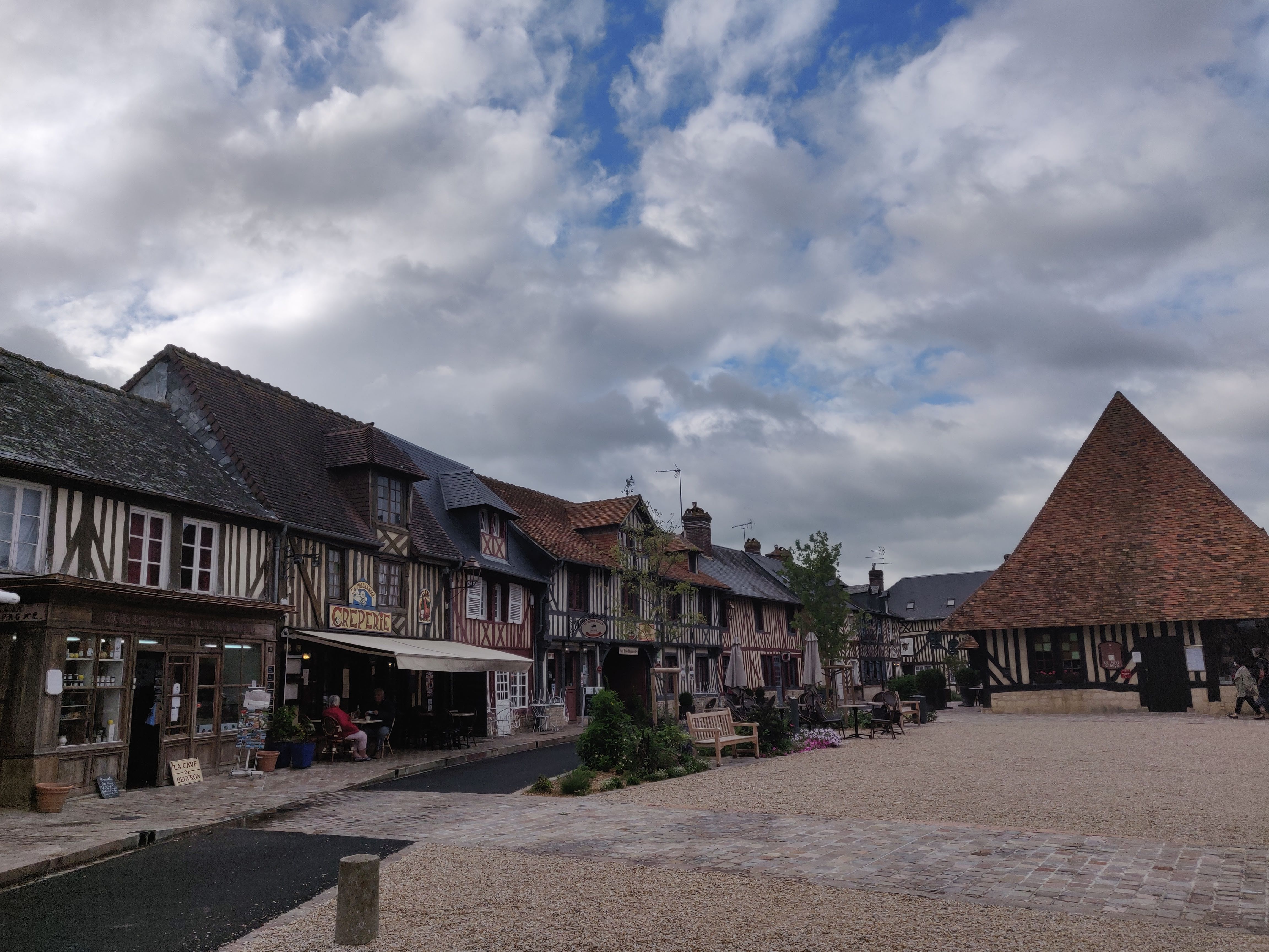 Picturesque half-timbered houses line a quaint street in Beuvron-en-Auge, Normandy.