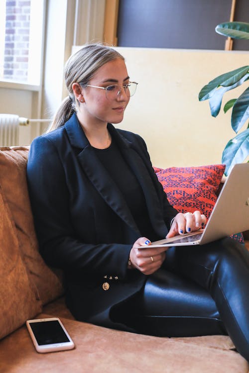 Woman in Black Blazer Using Silver Macbook