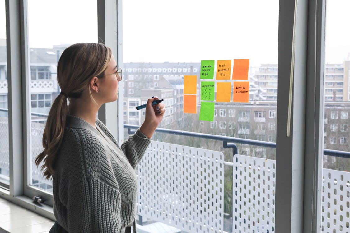 Career Woman looking at Sticky Notes