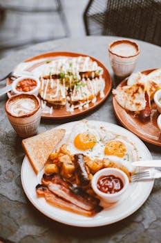 High-angle photo of a diverse breakfast meal with coffee, eggs, and toast on a table.