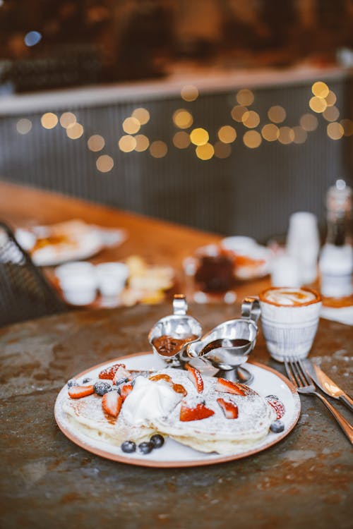 Free Pancakes with Slices of Strawberries and Blueberries in a Plate Stock Photo