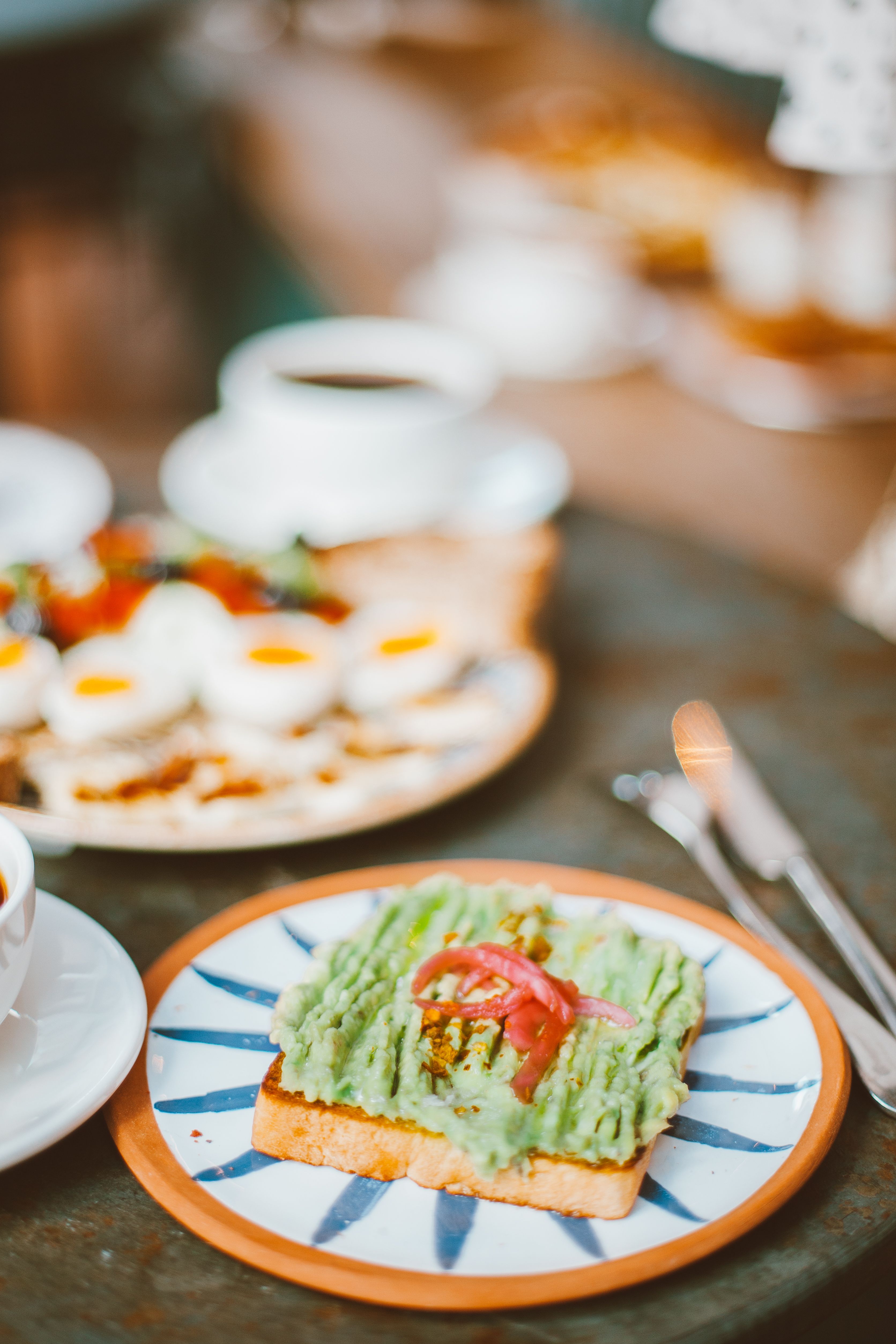 Delicious avocado toast and breakfast spread, beautifully styled on a rustic table.