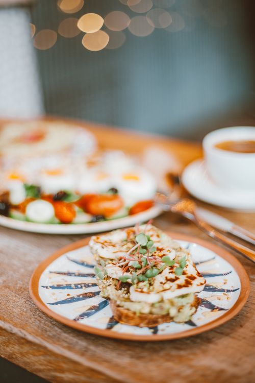 Free A delicious breakfast plate featuring toast with toppings and a cup of coffee, perfect for a morning meal. Stock Photo
