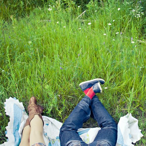 Two people lying on a blanket in a summer meadow — Scott Webb on Pexels