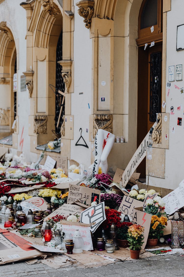 Flowers, Candles And Protest Banners In Front Of A Building In Poland During A Protest About Abortion Laws 