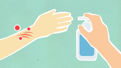 Paper cutout of person with contagious red viruses disinfecting hand with blue antiseptic during dangerous disease outbreak on green background