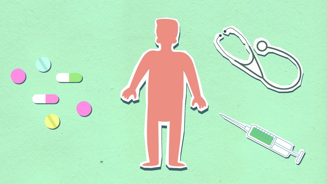 From above of decorative cardboard appliques of person between syringe with stethoscope and medications on green background