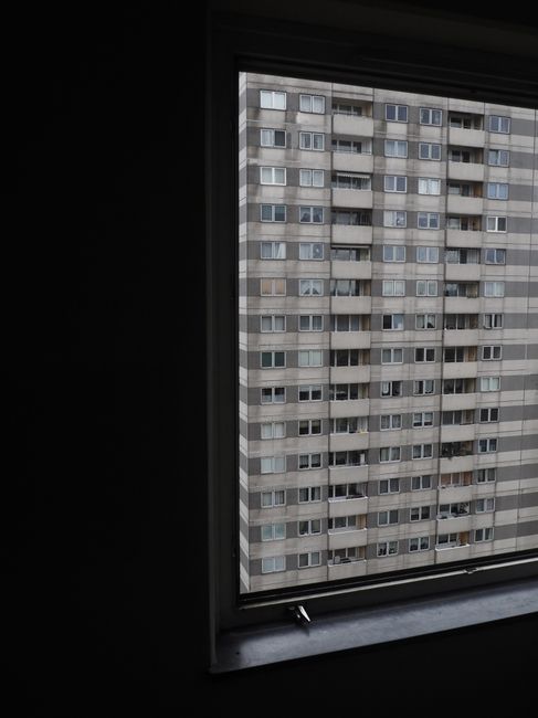 Urban Berlin high-rise building view through a window. Captures city architecture insight.